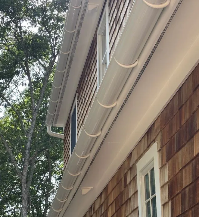 Half-round gutter running under a roof eave, seen from below